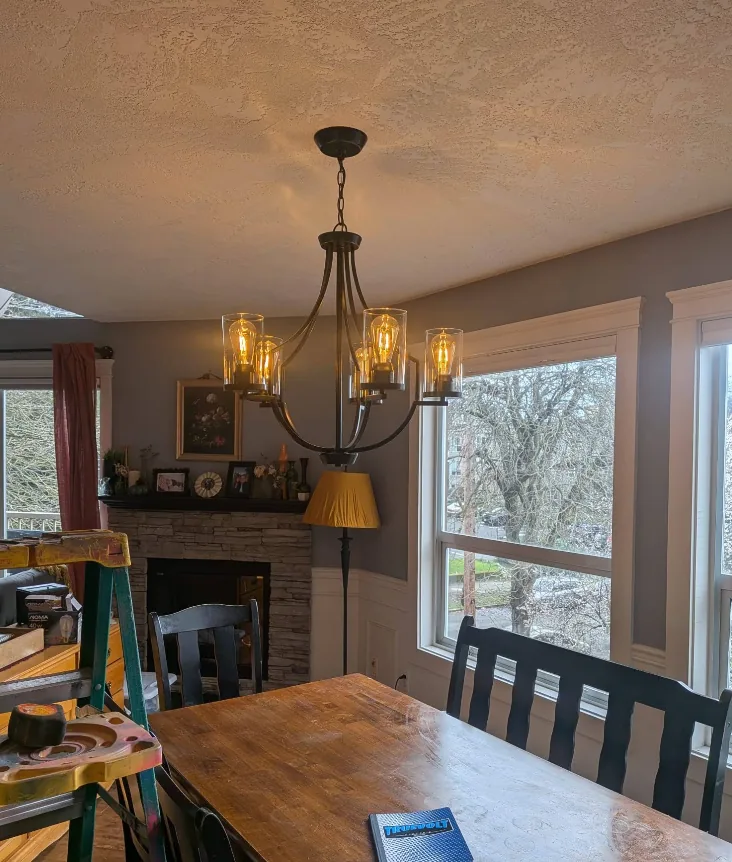 Dining room chandelier installed during a residential renovation