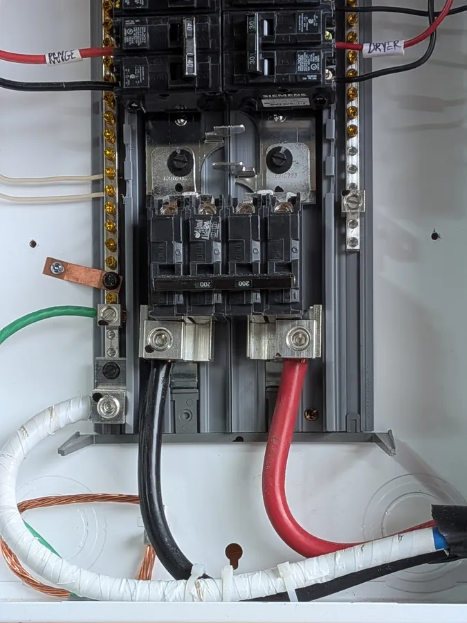 200-amp main breaker and service conductors inside a residential electrical panel