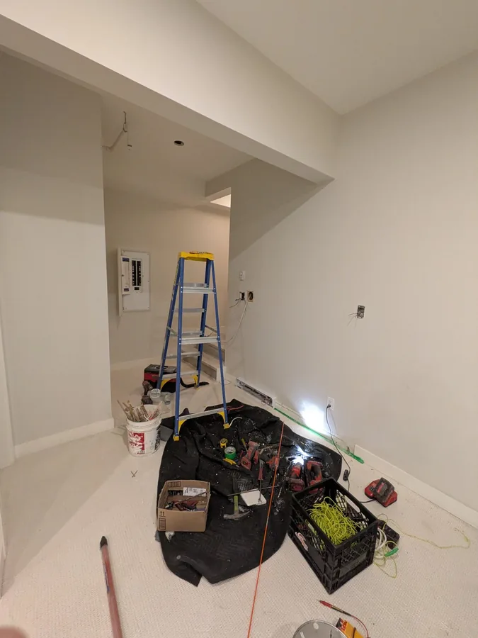Finished room with a ladder and tools during electrical work
