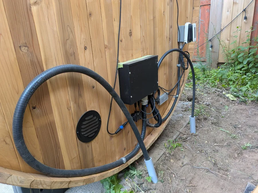 Electrical disconnect and conduit wired to a cedar barrel sauna